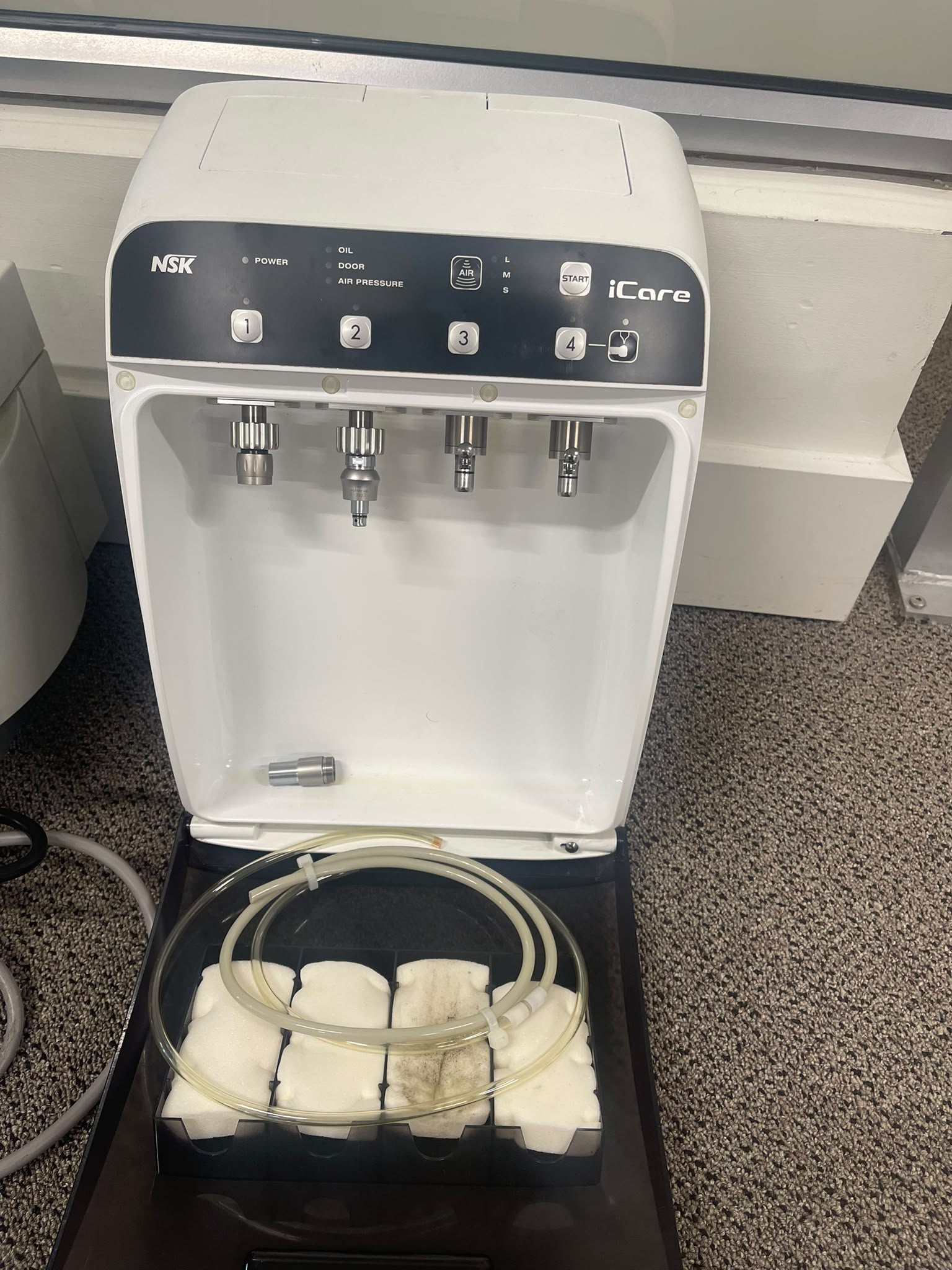 Pre-owned NSK iCare handpiece maintenance system with door open