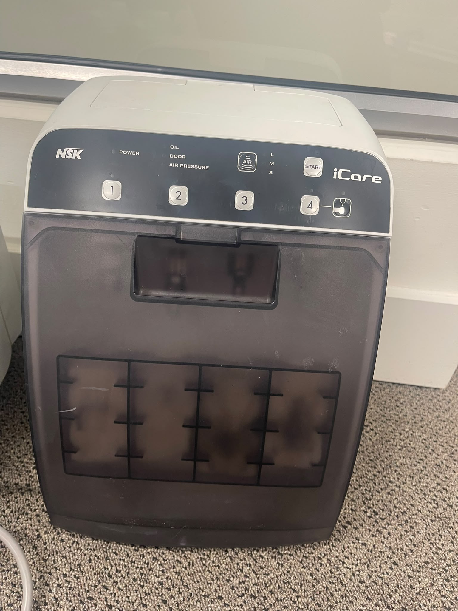 Pre-owned NSK iCare automatic handpiece maintenance system front view